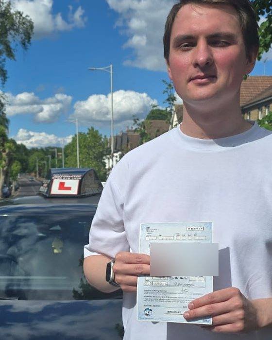 Automatic test pass — East London — learner with their pass certificate beside the East London Learners automatic car