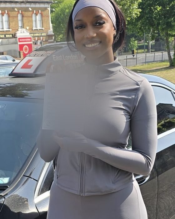 Automatic test pass — East London — learner with their pass certificate beside the East London Learners automatic car