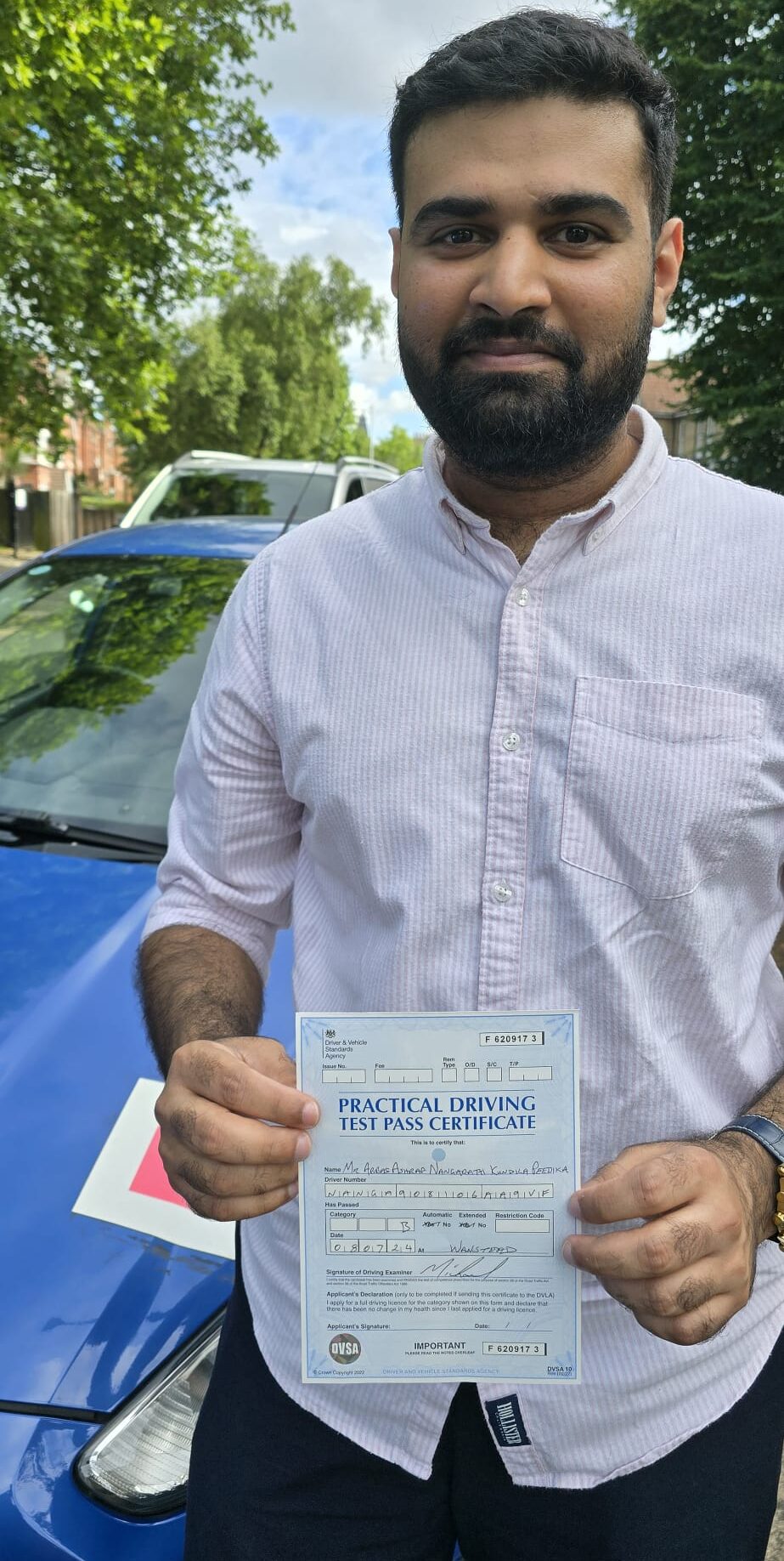 Learner celebrating a successful driving test after lessons near East London.