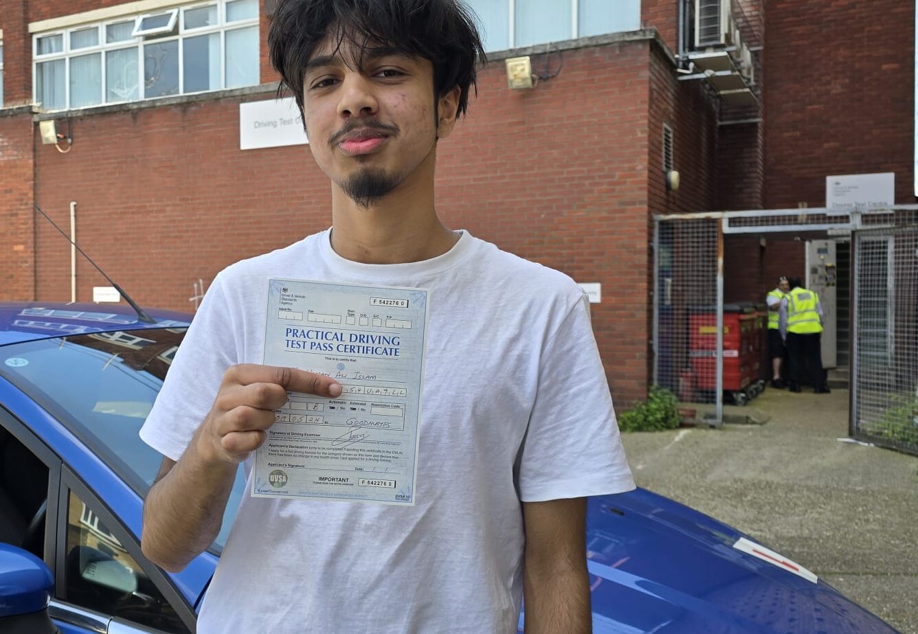 Confident driver showing their certificate after learning with automatic car instructors near Leytonstone.